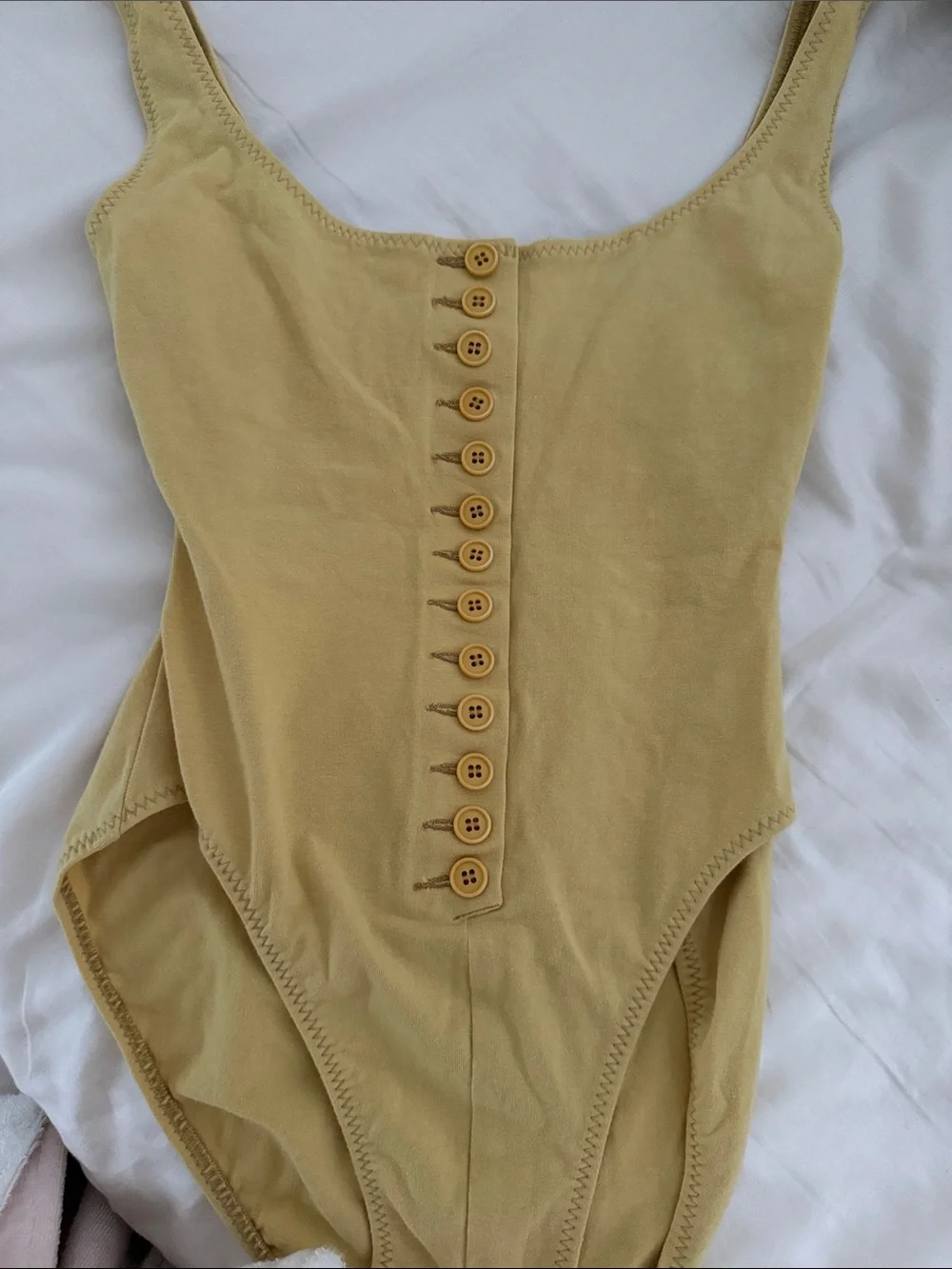 Norma Kamali , bodysuit Button-Front One-Piece in Mustard Yellow